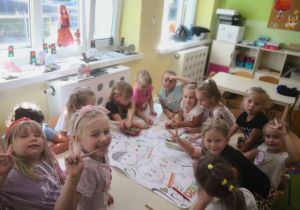 Dzieci kolorują plakat z okazji Dnia Przedszkolaka.