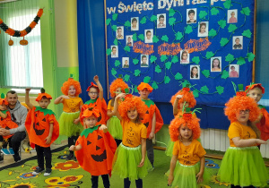 Dzieci w dyniowych kostiumach prezentują jesienny wiersz.
