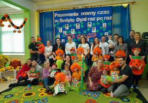 Dzieci wraz z rodzicami pozują do pamiątkowego zdjęcia z pasowania.