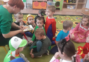 Mama dziecka czyta przedszkolakom książkę