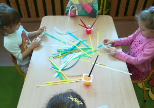 Dzieci sklejają kolorowy łańcuch.