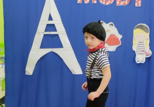Pokaz mody francuskiej- chłopiec w stroju małego Francuza.