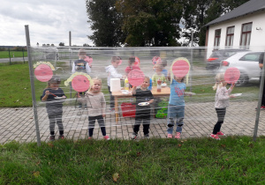Grupa dzieci maluje swoje portrety w plenerowej strefie kreatywności
