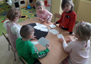 Dzieci przy stoliku podczas zabawy "Matematyczne igloo".